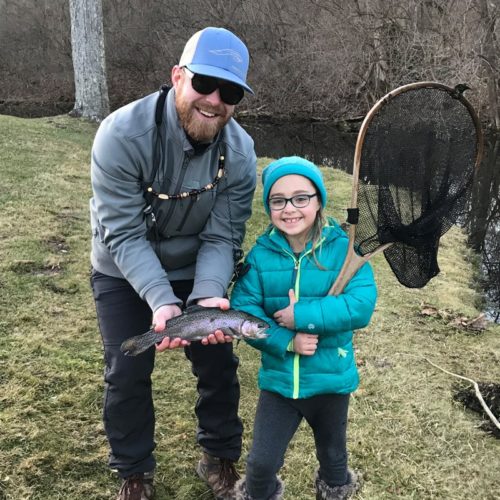 My son-in-law and his daughter during the winter season holding their trout