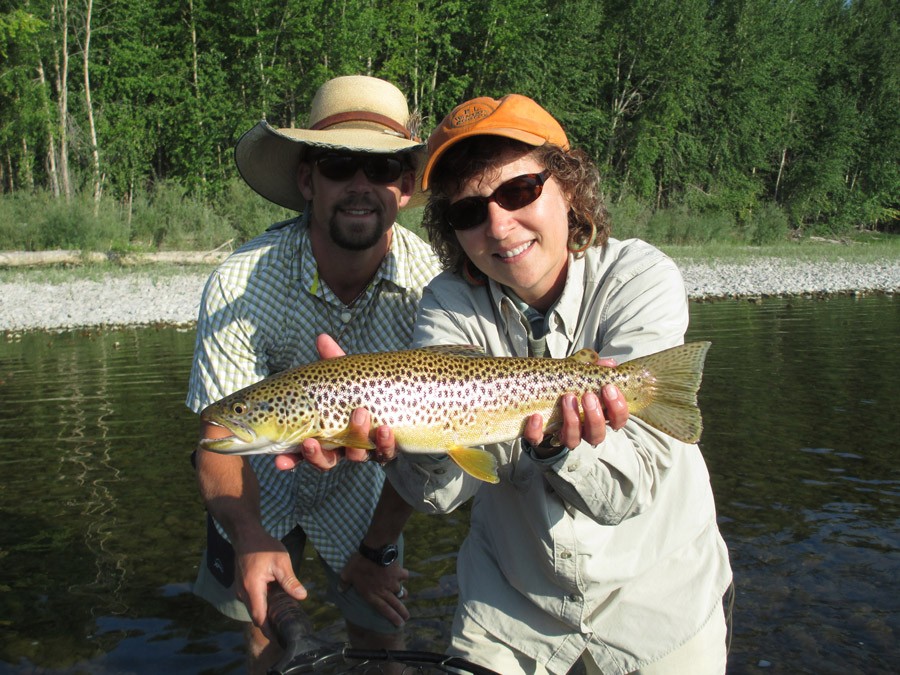 Melanie and James holding a trout caught at Clark Fork Brown