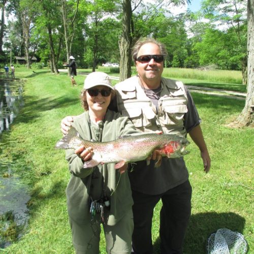 a older male friend of mine with my wife, Melanie, as the guide, holding a big trout caught on the spring creek in Ohio