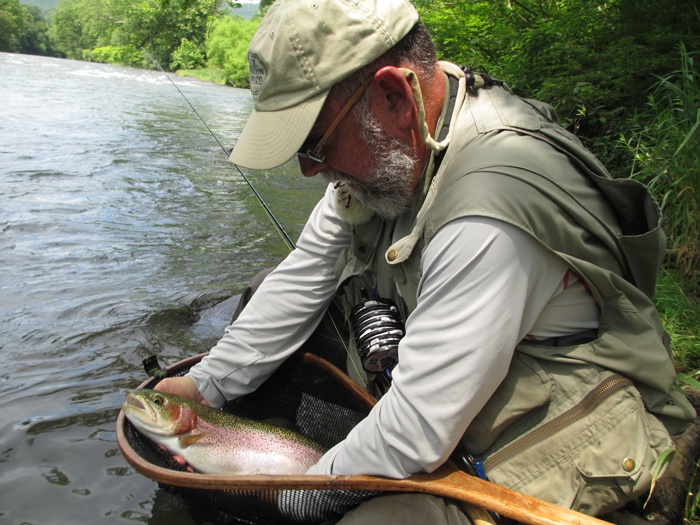 Me holding a rainbow trout in a net at the Little Juniata River