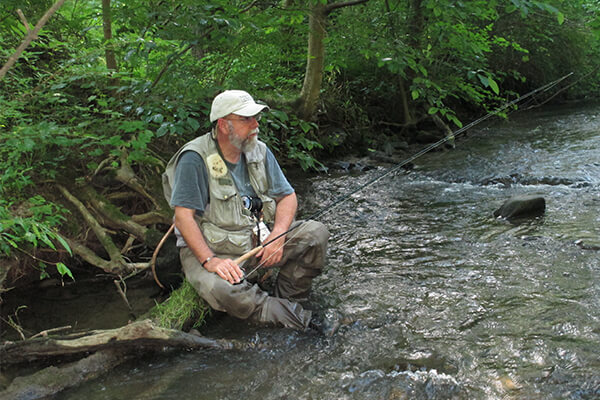 Me sitting on a rock looking for bugs.