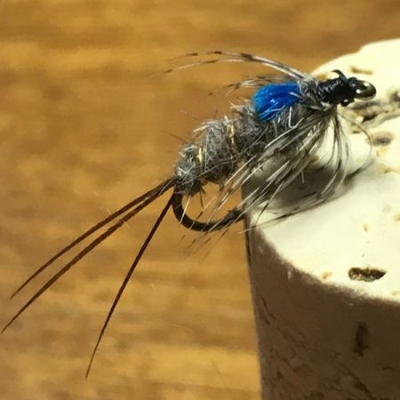 Kingfisher nymph hooked into a cork