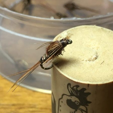 Pheasant tail nymph hooked into a cork